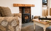 Chestnut Cottage - snuggle up on the armchair by the wood burning stove and enjoy a pot of tea