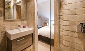 Coach House - bedroom two en suite bathroom on the first floor with walk-in shower, basin and WC