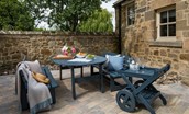 Coach House - outside seating area in the courtyard with bench seating and drinks trolley