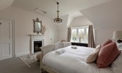 Gardener's Cottage, Twizell Estate - bedroom three with super king size bed, storage cupboard and decorative fireplace with mirror above