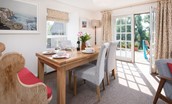 Coldstream Coach House - dining area with seating for six guests and door to patio area