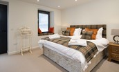 Coledale Stables - bedroom one on the ground floor with zip and link beds, side tables and window seat