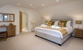Coledale Stables - bedroom three on the first floor with super king bed, dressing table, side tables and en suite bathroom