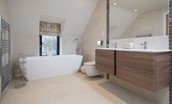 Coledale Stables - bedroom three en suite bathroom with free-standing bath, WC, double basins and walk-in shower
