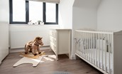 Sunwick Cottage - full size cot in bedroom three with a charming rocking horse for toddlers