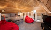 The Bothy at Redheugh - mezzanine level with TV, sofa and beanbags