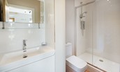 Granary - bedroom four en suite bathroom with large walk-in shower, WC and basin