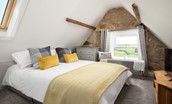 Castle View, Bamburgh - bedroom seven on the second floor with coombed ceiling and characterful original stonework