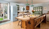 Castle View Cottage - the spacious kitchen is home to a rustic dining table with seating for up to eight guests