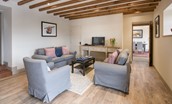 Crookhouse Mill - snug area with sofas, TV and door leading to open-plan sitting room and dining area