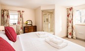 Crookhouse Mill - bedroom one with zip and link beds, chest of drawers and en suite bathroom