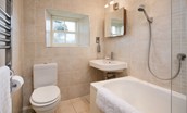Garden Cottage - tiled bathroom with bath and shower over, WC and basin