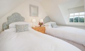 Garden Cottage - bedroom two with twin beds and chest of drawers