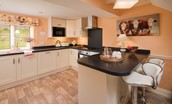Dryburgh Stirling Two - kitchen area with breakfast bar and two stools