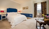 East House - bedroom four with king size bed, side tables and en suite bathroom