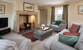 Dipper Cottage - sitting room with inglenook fireplace and wood burning stove