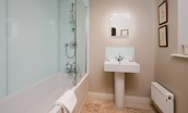 Countess Park - bedroom three en-suite bathroom with bath and shower over, WC and basin