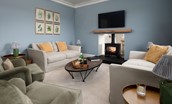 Riverhill Cottage - relax in the sitting room in front of the double-sided wood burning stove