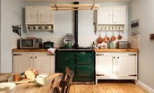 Castle View Cottage - a British Racing Green AGA sits centre stage with ceiling-mounted pulley above