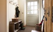Old Granary House - bright entrance hall with coat hooks and storage for outdoor kit