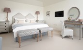 Hillside Cottage - bedroom one with zip and link beds, chest of drawers, dressing table and wall-mounted TV