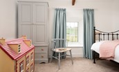 Appletree Cottage - a sweet child's bedroom with wrought iron bed and dolls house for play time