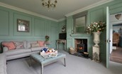 Gardener's Cottage, Twizell Estate - the elegantly styled sitting room with two large sofas, coffee table, wood burner and Smart TV