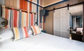 Berrington Beach Hut - ground floor bedroom with deckchair stripes adding a fun touch
