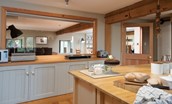 Heiton Mill House - kitchen with window looking through to open plan living area