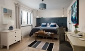 Seaside House - bedroom one with king size bed and stylish panelling which can be configured as twins upon request