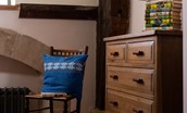 Lindisfarne View - bedroom two with chest of drawers and children's books