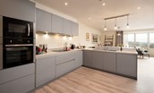 Old Granary House - beautifully modern open-plan kitchen with granite work surfaces overlooking the dining area
