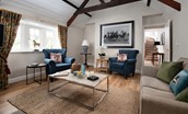 East End Cottage - the sitting room with original oak beams and ample seating for relaxation around the fire