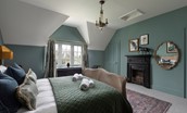 Gardener's Cottage, Twizell Estate - king size bed, decorative fireplace, mirror and storage cupboard in bedroom two