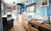 Berrington Beach Hut - dining area with bench seating
