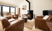 The Hemmel - cosy up on the sofa by the wood burning stove - please note, furniture has been updated. New photographs pending - 1 fabric sofa and 1 leather armchair now provided.