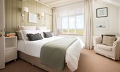 Marine House Cottage - bedroom one with sea views, king size bed, bedside tables and chair