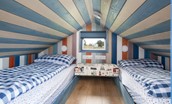 Berrington Beach Hut - upper floor bedroom has a beachy feel with twin beds