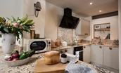 Anvil Cottage - the compact kitchen with oven, hob, dishwasher and microwave