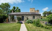 Poppy House - a period stone cottage with a contemporary conservatory and castellated tower