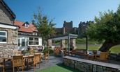Castle View, Bamburgh - the enclosed garden with plenty of outside seating and stunning views of Bamburgh Castle