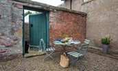 Mullins House - gravelled dining area with seating for 4 guests