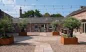 Willow Cottage - courtyard to the front of the property with atmospheric festoon lighting