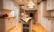 The Craftsman's Cottage - kitchen with feature woodburner and central island