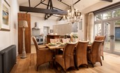 Coach House - open-plan kitchen and dining area with French doors leading to the courtyard