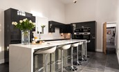The Steading at West Lyham - contemporary monochrome kitchen with large island and breakfast bar