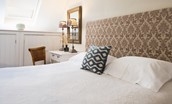 Swan's Nest - bedroom one with lovely cottage detailing and crisp white linen