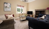Birch Cottage - sitting room with sofas and log burner