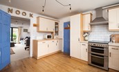 Nook - well-equipped kitchen with electric fan oven, 4 ring hob, coffee machine, free-standing fridge/freezer, and dishwasher