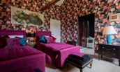 Lowtown Cottage - bedroom one with twin beds and dramatic floral wallpaper